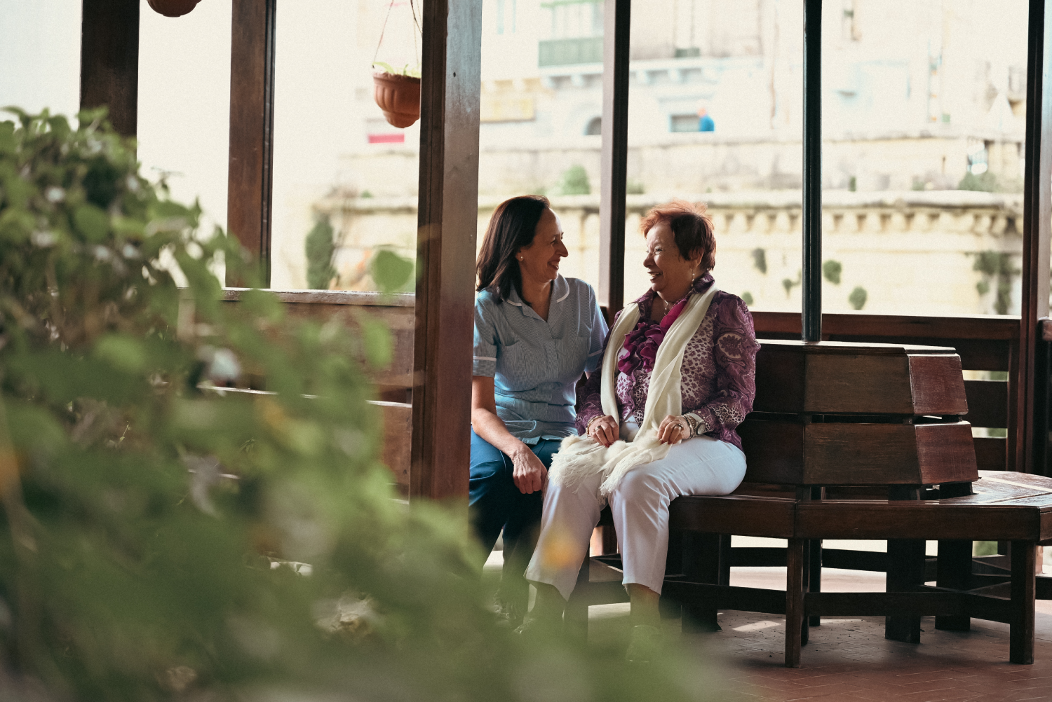 Vassallo Group representatives engaging with elderly community members during a social care initiative in Malta